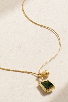 Pippa Small designs jewelry for those "who find the beauty and uniqueness in imperfection" - each stone is left in its original and natural state. Made from 18-karat gold and cord, this necklace is strung with a seed-shaped charm and a stunning green tourmaline that's believed to bring abundance and good fortune to the wearer. Yellow Gold Tourmaline Gemstone Necklace, Elegant Tourmaline Yellow Gold Necklace, Elegant Green Tourmaline Necklace, Gold Tourmaline Pendant Jewelry, Pippa Small Necklace, Tourmaline Necklace, Drawstring Pouch, Good Fortune, Cord Necklace