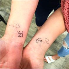 two people with matching tattoos on their arms