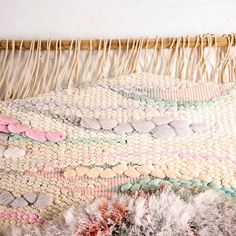 a close up of a woven rug on a bed with a wicker headboard