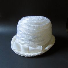 "This vintage women's white cellulosic bucket/cloche/pillbox hat featuring a 5 3/4\" width offset bow and 1 3/4\" height upturned brim is 6\" in height, 21 3/4\" around the perimeter of the interior comfort band (approximately a size 7 medium), and maintains it's original Hatters, Cap & Millinery Workers Union International tag... very 1960's." White Bucket Hat For Kentucky Derby, White Wide Brim Hat For Gift, White Wide Brim Hat As Gift, Elegant White Bucket Hat, White Bucket Mini Hat One Size, White Bucket Hat Mini Size, Vintage White Hat, One Size Fits Most, Vintage White Cloche Mini Hat, White Vintage Cloche Mini Hat