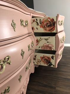 a pink dresser with flowers painted on it