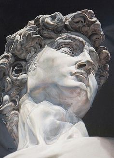 a close up of a statue of a man with curly hair