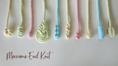 there are many different colored ropes on the table with one knot in the middle and another knot at the end