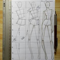 a drawing of different types of clothes on a piece of paper with a ruler next to it