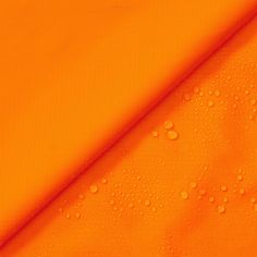 an orange fabric with water drops on it