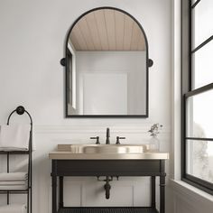 a bathroom with a sink, mirror and towel rack on the wall next to it