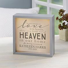 a white box frame with the words love is in heaven, there is a little bit of heaven in our home