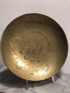 a gold plate sitting on top of a marble table