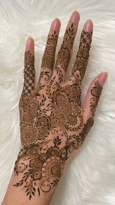 the hand is decorated with henna and flowers