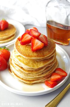 a stack of pancakes with strawberries on top