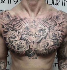 a man with tattoos on his chest has roses and a cross in front of him