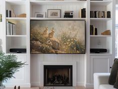 a living room filled with furniture and a painting on the wall above a fire place