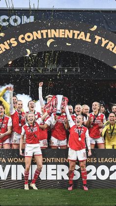 the women's soccer team is celebrating with their trophy