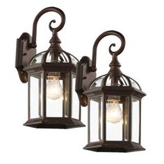 This 2-pack of wall lanterns will enhance your landscape with a perfect mix of form and function. The 15.75 in. wall lights are open at bottom for easy bulb change. Features include a decorative scroll sconce arm, scalloped edges on wall cover plate, and clear beveled glass sides and roof. With their simple but versatile design, these-pieces are a perfect complement anywhere from the front of your home to the backyard deck and garden. Outdoor Wall Light Fixtures, Craftsman Exterior, Black Outdoor Wall Lights, Wall Light Fixture, Wall Lanterns, Exterior Wall Light, Outdoor Sconces, Outdoor Light Fixtures, Outdoor Wall Lantern