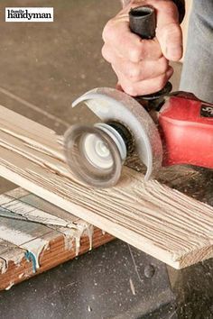 a man using a circular saw to cut wood with a grinder on the table