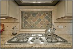 a stove top oven sitting inside of a kitchen next to a tile backsplash