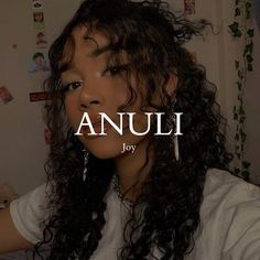 an image of a woman with long curly hair in the background that says annu joy