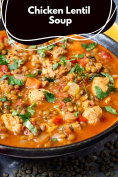 chicken lentil soup in a black bowl with cilantro on the side