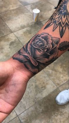 a person with a rose tattoo on their arm