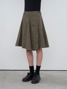 This sophisticated herringbone wool-blend wrap skirt combines classic pattern with modern flair, featuring a flattering A-line silhouette and secure button closure. The luxurious fabric blend, incorporating wool, polyester, cotton, and tencel, ensures both warmth and comfort during the cooler seasons. Available in a versatile beige and black colorway, this knee-length skirt offers the perfect balance of timeless elegance and contemporary style.Color: BEIGE, BLACK Beige And Black, Wool Skirts, Classic Pattern, Knee Length Skirt, Luxury Fabrics, Wrap Skirt, Herringbone, Contemporary Style, Timeless Elegance