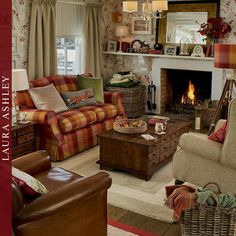 a living room filled with furniture and a fire place in the fireplace area next to a window