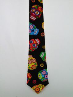 "Sugar Skull necktie for men. Stand our at the Halloween party with this colorful tie. Features a black background with the following colors: Yellow, Red, Green, Blue and White. Expertly hand-made from 100% cotton you can select your length from 57\" to 71\" (Great for taller Men). Width is standard 3.5\" as shown here or skinny 2.5\". If you require a custom length or width, please contact us. 2.5\" x 48\" Child size available upon request. Ships within 2 business days. Made in the USA. CUSTOM Make A Tie, Goth Wedding, Tall Guys, Halloween Gift, Gift For Men, Ties Mens, Necktie, Sugar Skull, Halloween Gifts