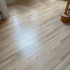 an empty room with hard wood floors and white walls