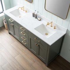 a bathroom with two sinks and mirrors on the wall