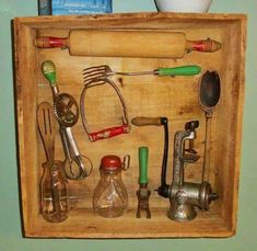 an old wooden box filled with kitchen utensils