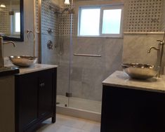 a bathroom with two sinks and a shower