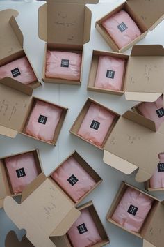 several open boxes with pink tissue in them