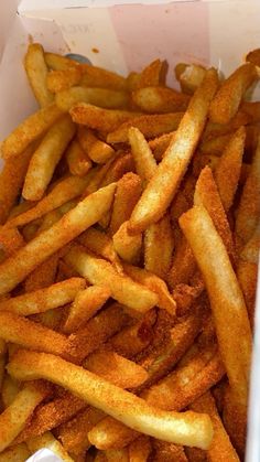 french fries in a white box on a table