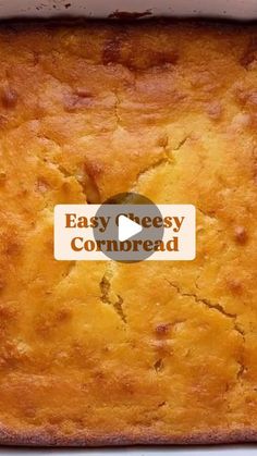 a close up of a cake in a pan with the words easy cheesy cornbread on it