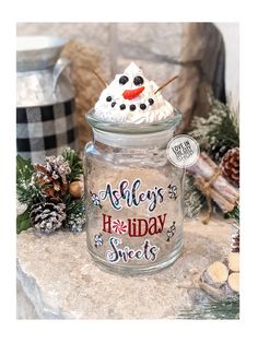 a glass jar filled with frosted holiday treats