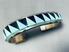 MAKE US AN OFFER BY CLICKING THE "MESSAGE SELLER" Button- This is a fabulous vintage Navajo inlaid silver cuff bracelet. This remarkable bracelet contains a fascinating graduating inlaid silver cuff that is thick and sturdy. I absolutely love how the cuff graduates in width from one end to the other with the widest end measuring around 5/8". The inlay consists of triangular shaped turquoise and onyx stones. Bordering the thick edges of the cuff are phenomenal as they consist of channeled works a Big Jewelry, Navajo Turquoise, Vintage Navajo, Onyx Stone, Silver Cuff Bracelet, American Jewelry, Sterling Silver Bracelet, Silver Cuff, Sterling Silver Bracelets