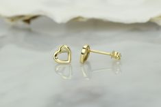 14k gold heart earrings, made with a delicate design and size. The smooth surface and lines give you a jewelry piece that will complete your outfit for work, leisure, or even special occasions. 💎Design: Delicate open heart earrings 💎Material: 14k solid gold and and a layer of E-Coating that acts as protection against tarnish and scratches ,which will keep your earring looking spotless 💎Earrings size: 6.2mm x 6.5mm The earrings come in a charming jewelry box. Additionally, you will also get a 14k Gold Pierced Double Heart Earrings, 14k Yellow Gold Open Heart Earrings, Yellow Gold Sterling Silver Open Heart Earrings, Pierced Heart Cut 14k Gold Heart Earrings, 14k Gold Heart Cut Pierced Heart Earrings, 14k Gold Heart Cut Pierced Earrings, Dainty Yellow Gold Heart Cut Earrings, Minimalist Pierced Yellow Gold Heart Earrings, 14k Gold Heart Earrings With Heart Charm