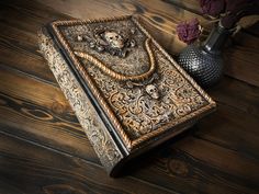 an old book with a skull and crossbones on it sitting on a wooden floor