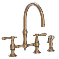 an antique style kitchen faucet with two handles and side sprayers in brass