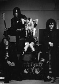 the pretty reckless band posing with their guitars