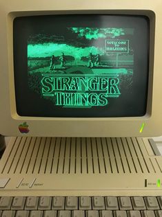 an old computer with the words stranger things on it