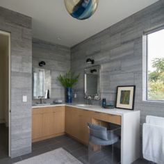 a large bathroom with two sinks and mirrors