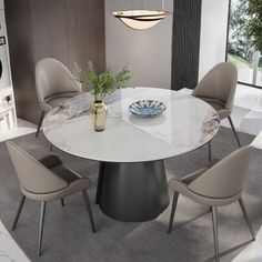 a dining room table with chairs and a vase on the table in front of it