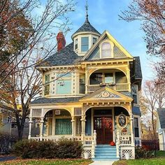 an old victorian house with blue and yellow trim