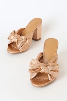 We love the flirty look of the Dorothea Rose Gold Knotted High Heel Sandals! Metallic, pleated fabric shapes a these adorable heels with a knotted bow atop the peep-toe upper and a sturdy block heel. Easy to wear, slide-on design. Chic Block Heel Heels With Satin Bow, Chic Block Heels With Satin Bow, Chic Sandals With Satin Bow For Summer, Spring Party Heels With Satin Bow, Party Heels With Satin Bow For Spring, Gold Heels With Bow For Summer, Feminine Summer Heels With Bow, Gold Sandals With Bow For Party, Summer Party Heels With Satin Bow