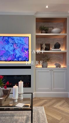 a living room filled with furniture and a flat screen tv mounted on the wall above a fireplace