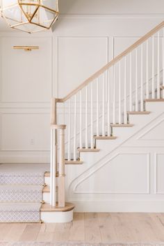 an empty room with white walls and stairs