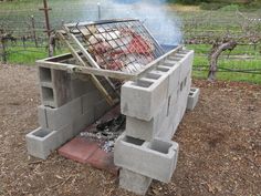 an outdoor grill made out of cinder blocks