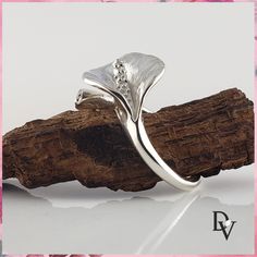 Smart Buys! Calla Lily Sterling Silver Leaf Ring - Adjustable - Flower Ring - Midi Ring - Silver Leaf Ring by DV Jewelry Designs starting from $95.00 See more. 🤓 #OliveLeafRing #LeafRing #AdjustableRing #GoldEngagementRing #IndexFingerRing #MiddleFingerRing #SilverLeafRing #AnniversaryGift #EngagementRing #MidiRing Sterling Silver Diamond Flower Ring In Fine Jewelry Style, Unique White Gold Flower Ring For Wedding, Unique White Gold Flower Ring As Gift, Unique White Gold Flower Ring For Gift, Elegant Handmade White Gold Flower Ring, Elegant Sterling Silver Flower Ring With Polished Finish, White Gold Flower Ring With Polished Finish As Gift, Polished White Gold Flower Ring Gift, Unique White Gold Flower Ring For Anniversary