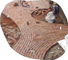 a brick walkway being built in the middle of a yard