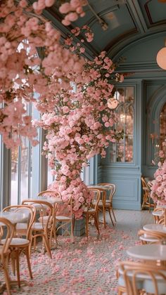 a room with tables and chairs covered in pink flowers